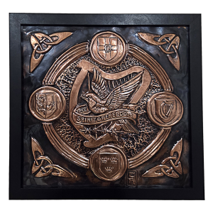 Bronze-toned embossed plaque with an soaring eagle and ribbon 'The Spirit of Freedom' amid circular emblems and Celtic knots in a black frame